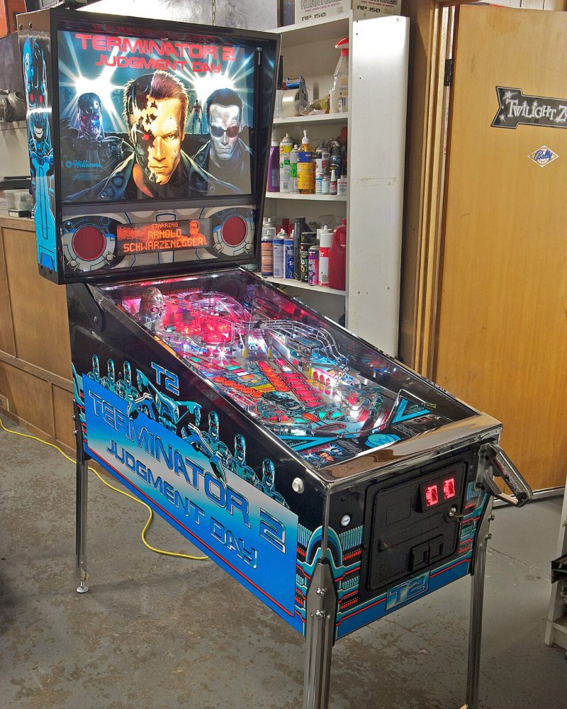 Terminator 2: Judgment Day pinball machine with lit backglass and playfield